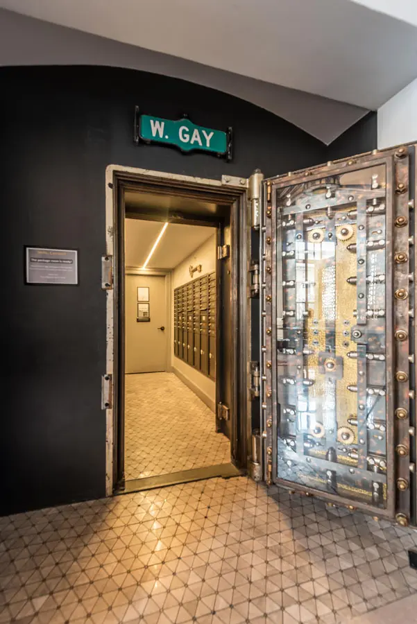 Ornate metal door with W Gay sign above it.