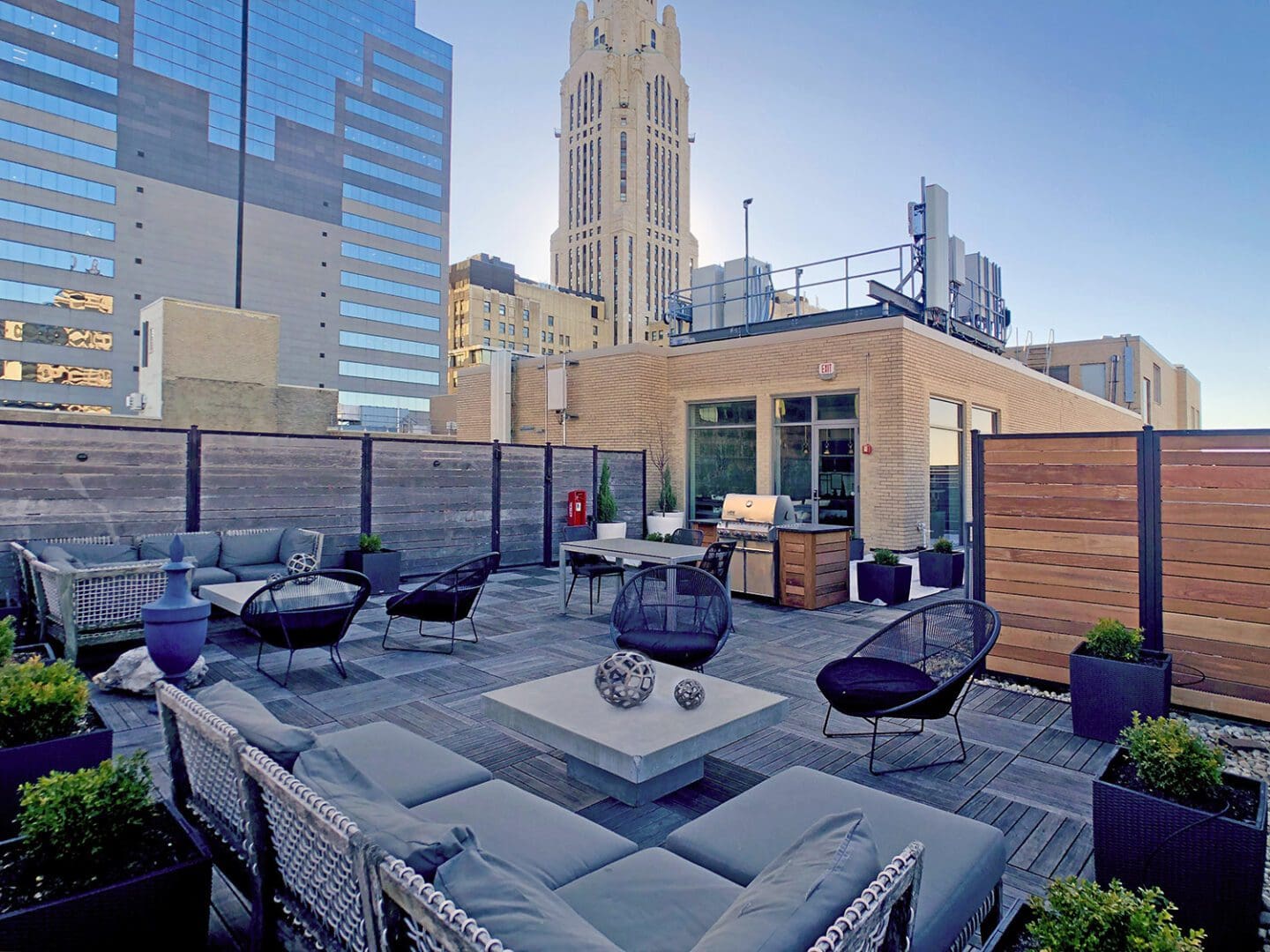 Rooftop patio with modern furniture and skyline.