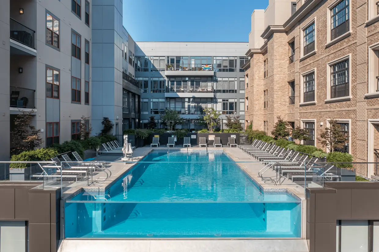 Rooftop apartment pool between brick buildings