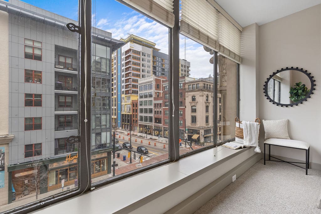 Apartment interior with large windows overlooking city