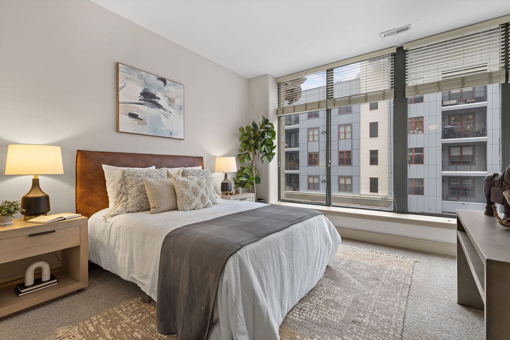 Modern bedroom with large city-facing windows