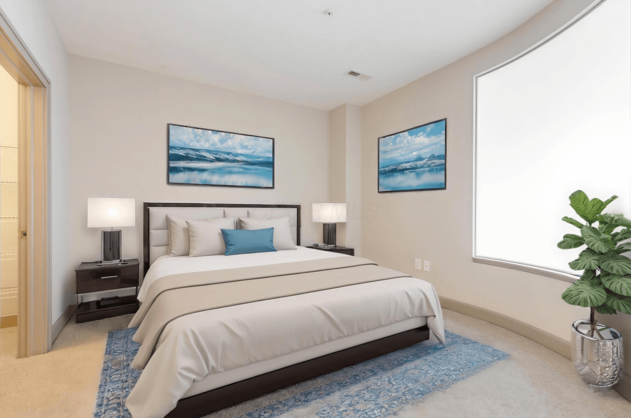 Modern bedroom with bed, lamps, and plant