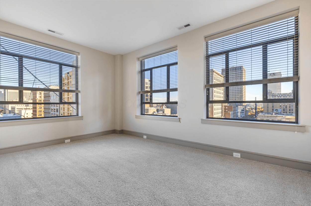 Empty room with large city-view windows
