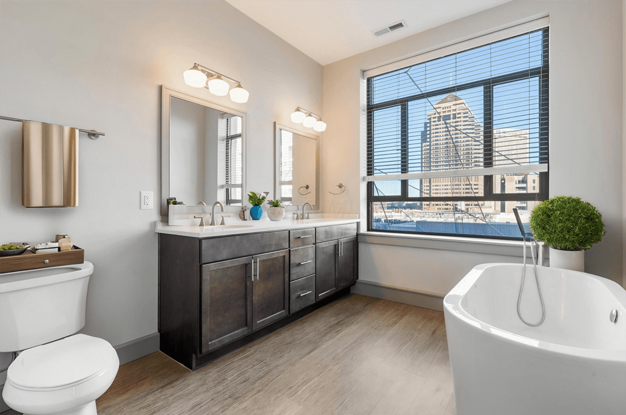 Modern bathroom with freestanding tub, city view