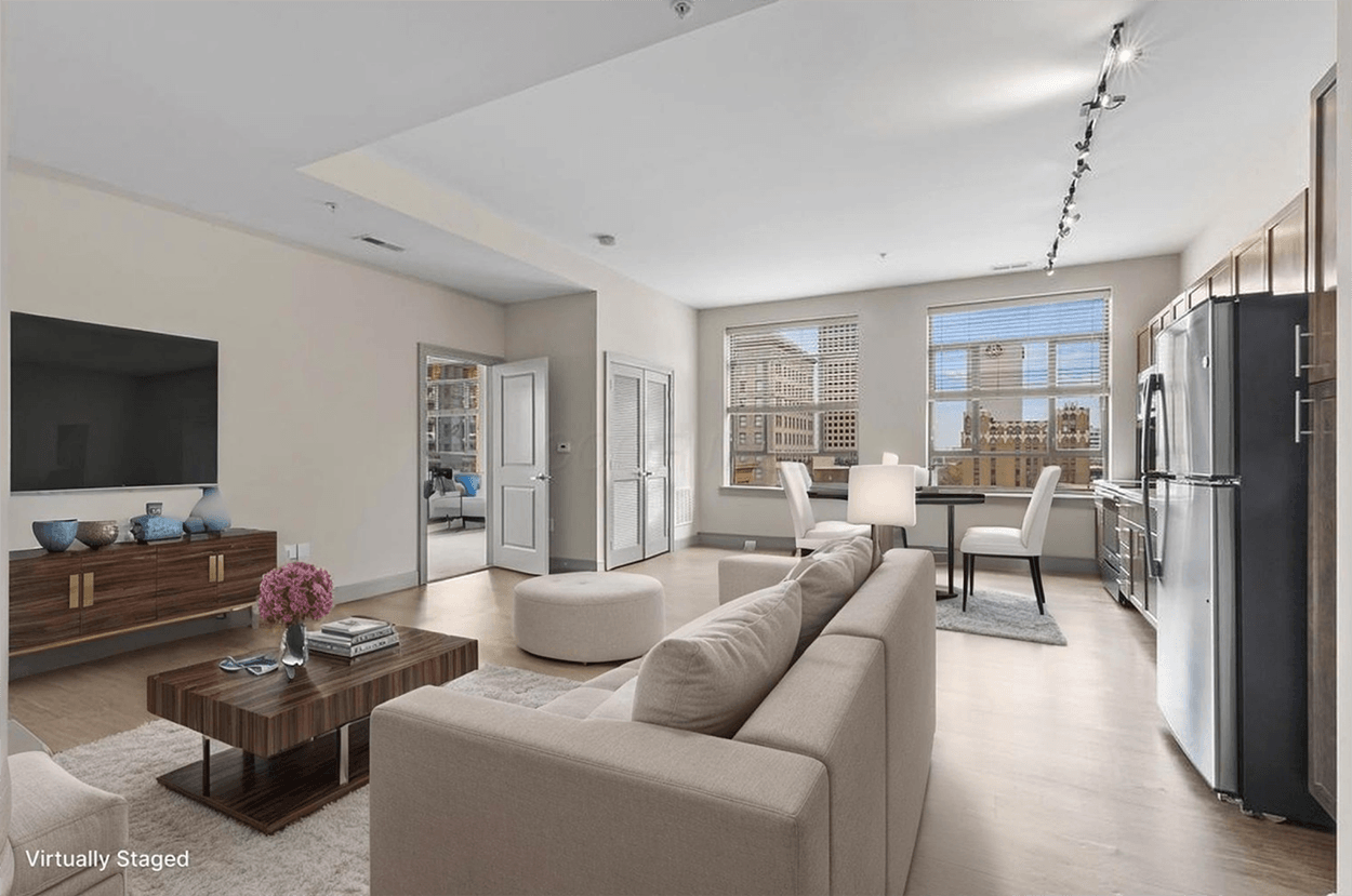 Open-plan living room and kitchen with city view