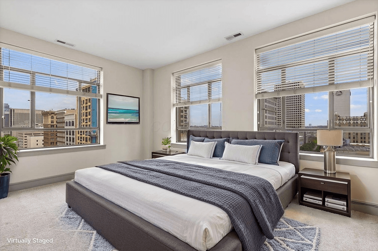 Modern bedroom with city skyline view